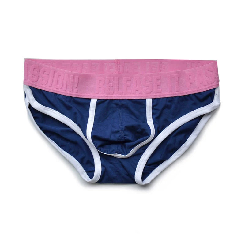 Front view of navy briefs with white trim and a pink embossed waistband reading “PUP RELEASE.”