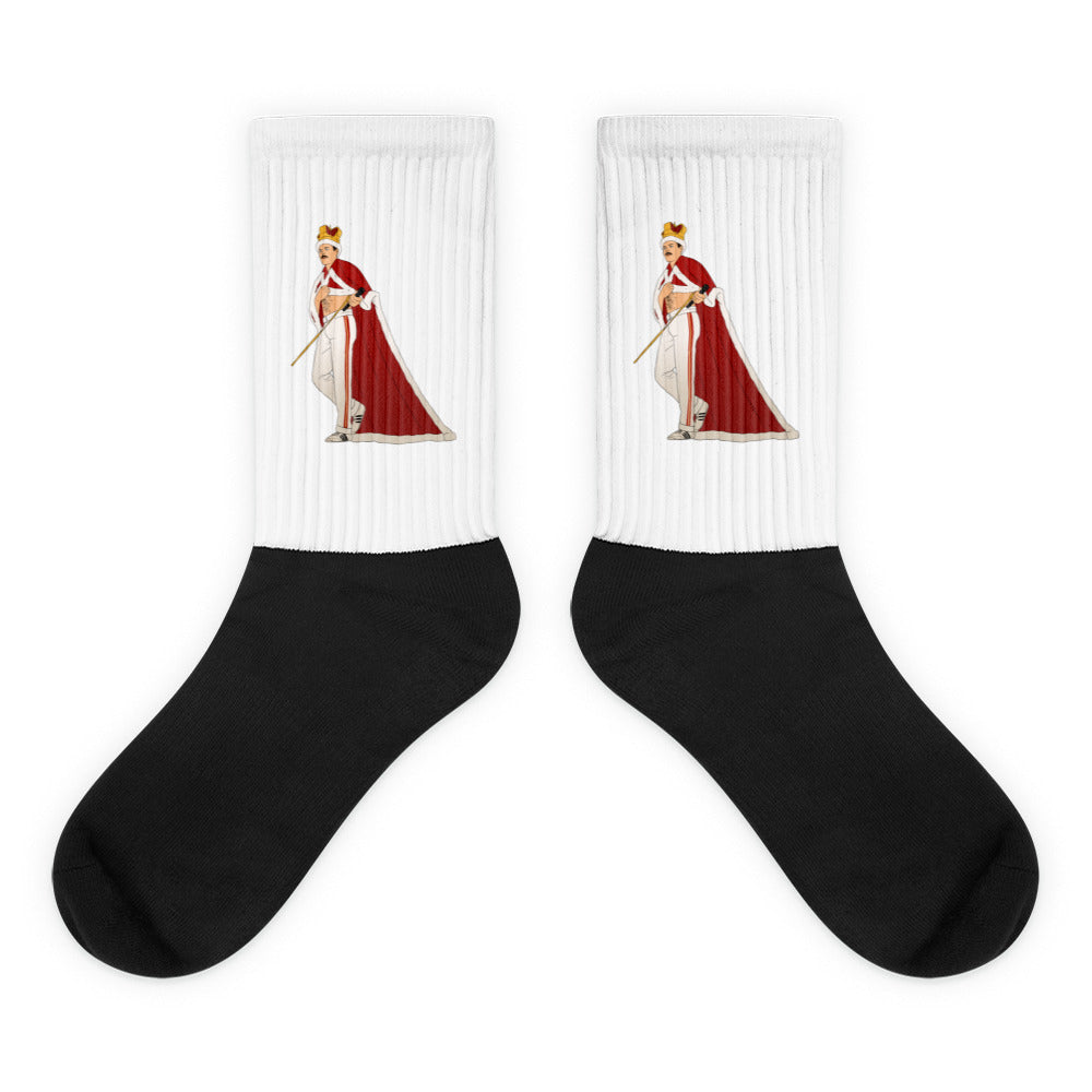 Pair of black-and-white socks with a crowned, caped figure holding a cane