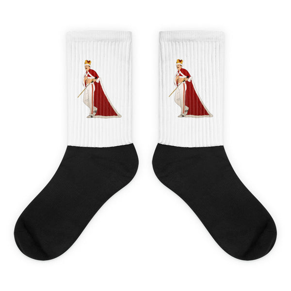 Pair of black-and-white socks with a crowned, caped figure holding a cane