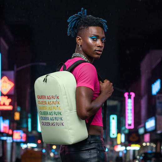 Queer As Fu*k Minimalist Backpack, carried with pride by a bold person in blue hair, pink crop top, black pants at night