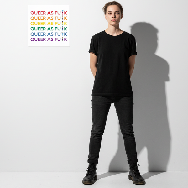 Queer As Fu#k poster with bold rainbow lettering on matte paper, shown against a white wall and person in all-black
