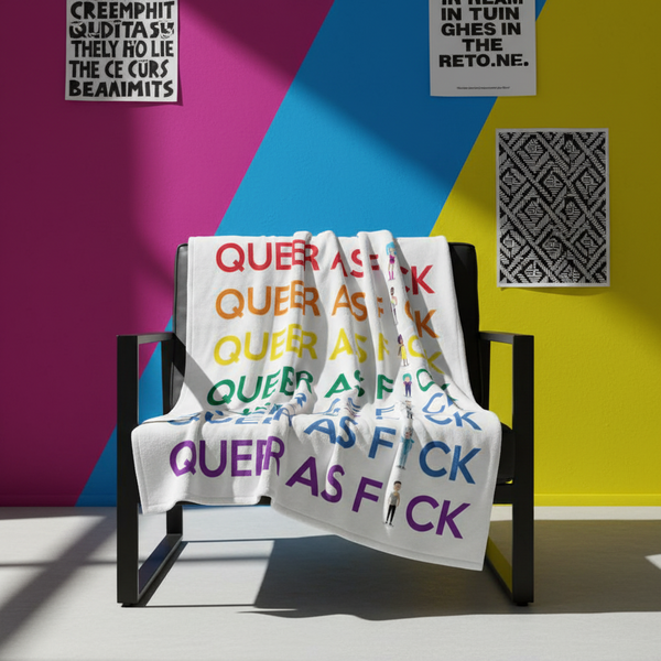 Queer As Fu#k Throw Blanket with vibrant, repeated slogan draped on a chic chair; bold blue, pink