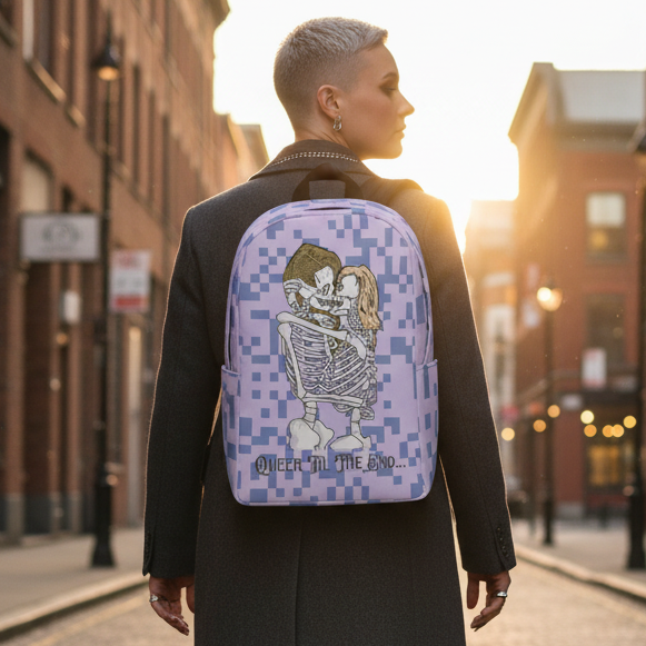 Queer Til The End Minimalist Backpack with a pixelated skeletons graphic and “OVER IN THE END...” slogan