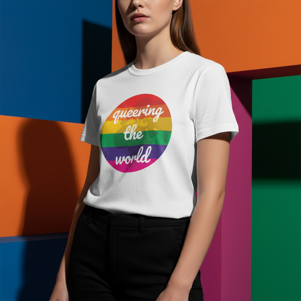 Queering The World T-Shirt in cotton, rainbow circle and "queering the world" cursive, on person, bold backdrop