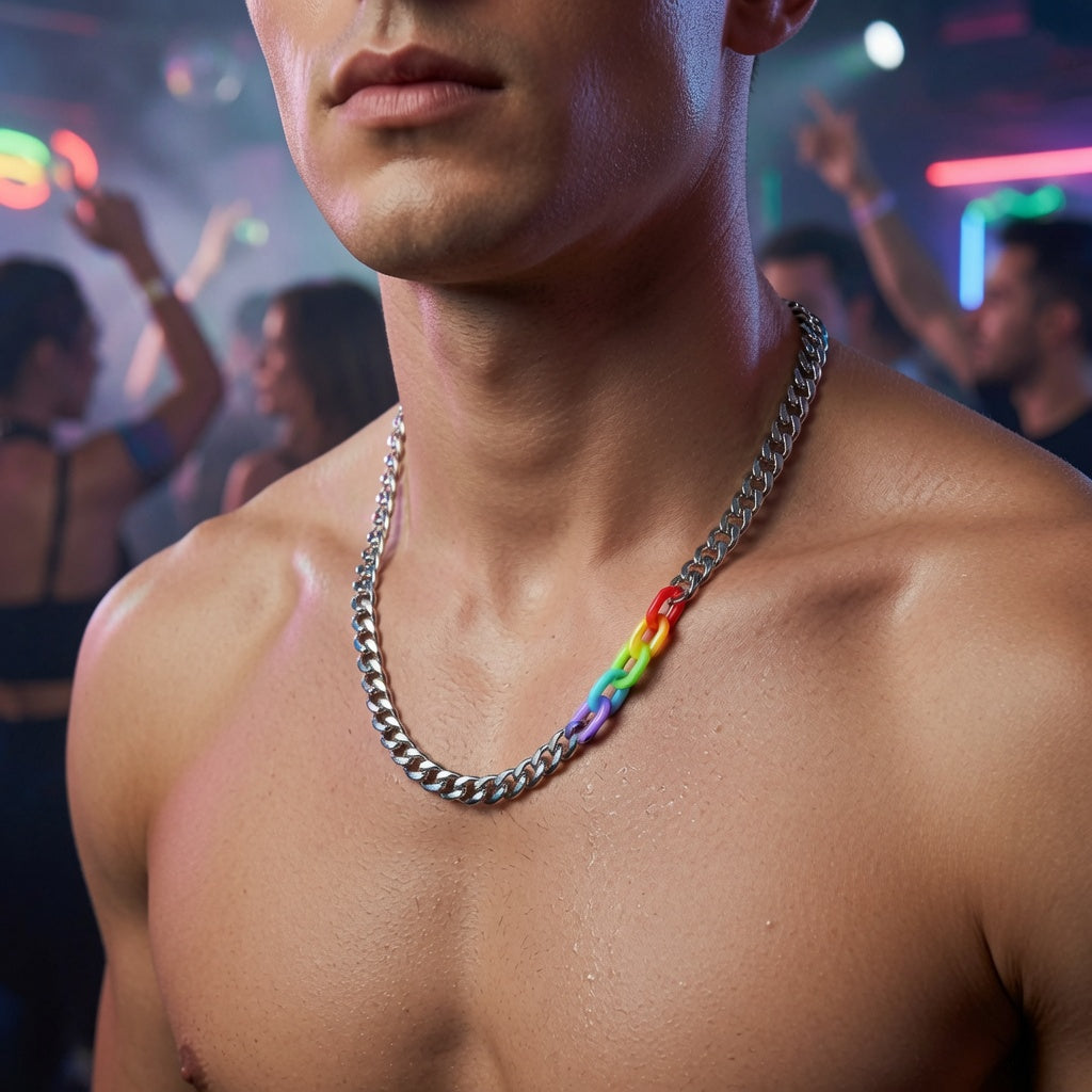 Close-up of a shirtless model wearing a silver chain necklace with rainbow-colored links