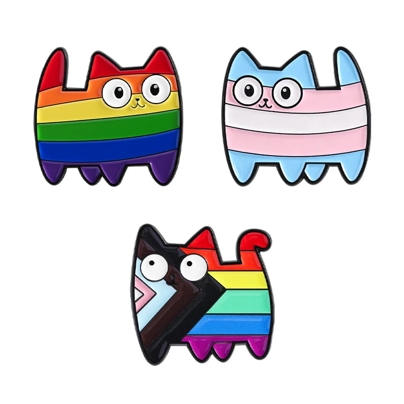 Three cat enamel pins with rainbow, trans pride, and multicolor geometric designs