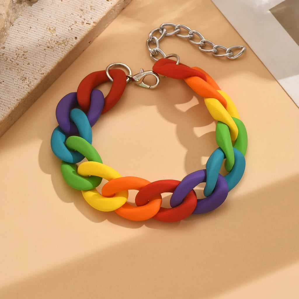 Rainbow bracelet with chunky multicolored links and a silver chain extension, shown on a surface