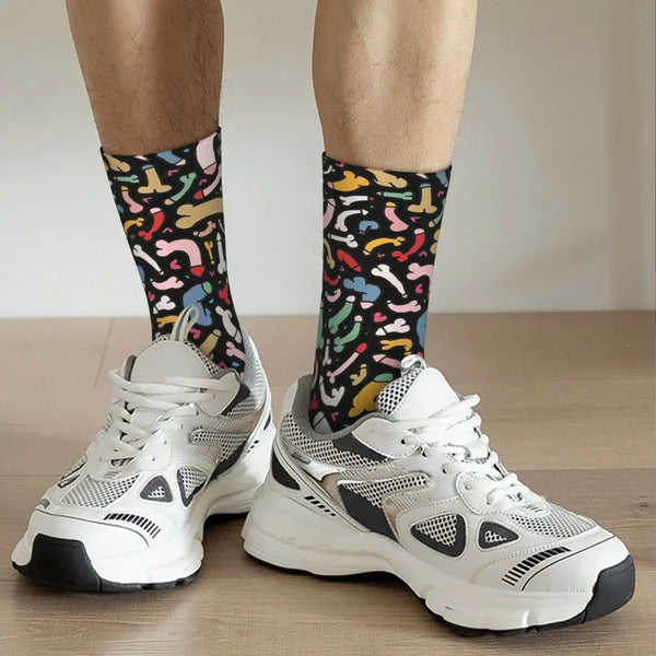 Person wearing black crew socks covered in colorful penis-shaped prints with white sneakers