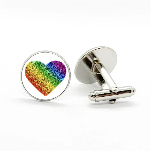 Pair of silver-tone cufflinks, one with a glittery rainbow heart and one showing the toggle backing