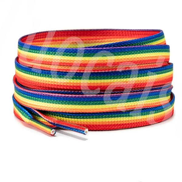 Coiled rainbow-striped shoelaces with two loose capped ends on a white background