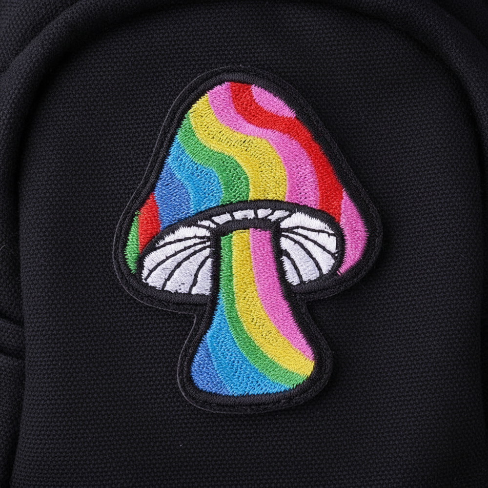 Rainbow mushroom embroidered patch with colorful stripes on black fabric