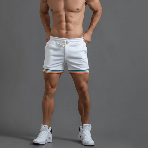 Front-view model wearing white running shorts with rainbow-striped hems