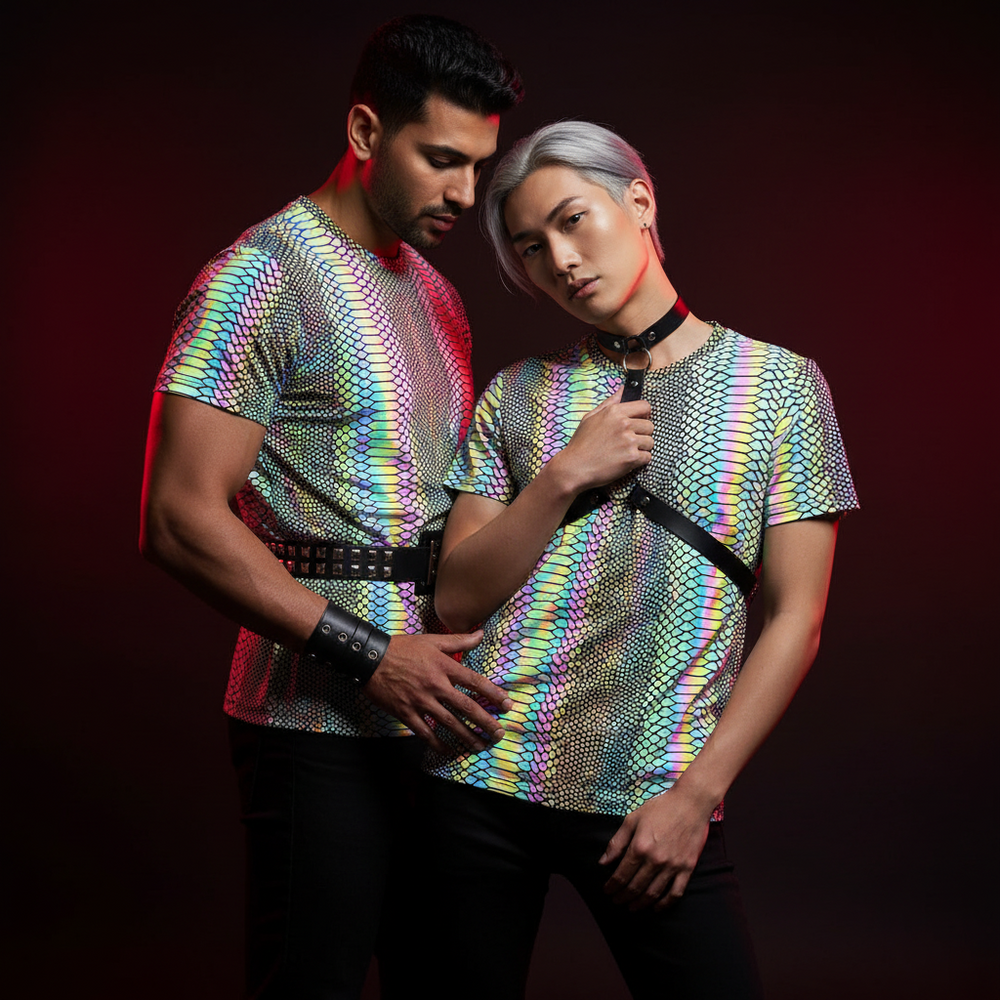 Two models wearing iridescent rainbow snake-pattern T-shirts in a dark studio