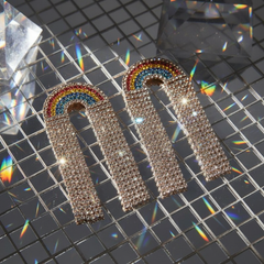 Rainbow Rhinestone Earrings glisten with rainbow arches and dangling rhinestone strands, capturing prideful elegance. Perfect for parades or parties, these earrings embody bold queer self-expression and dazzling visibility.