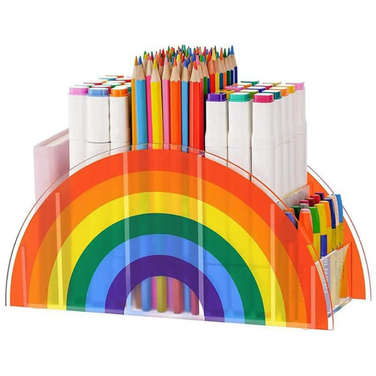 Clear rainbow-shaped desk organizer holding colored pencils, markers, and pens