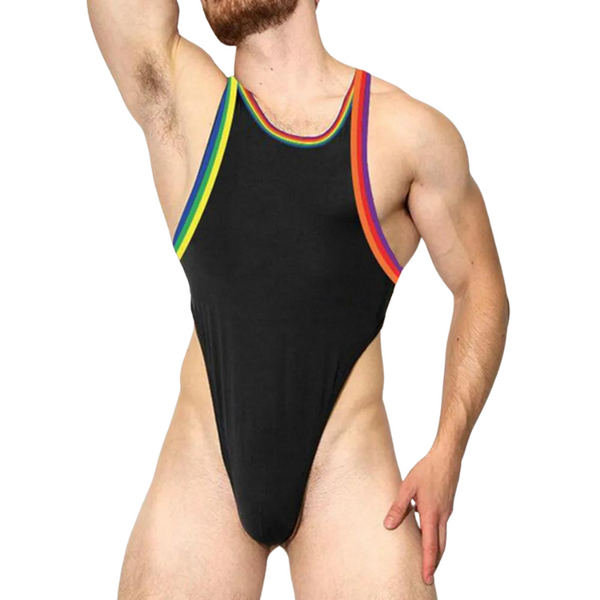 Front view of a bearded person wearing a black thong bodysuit with rainbow trim
