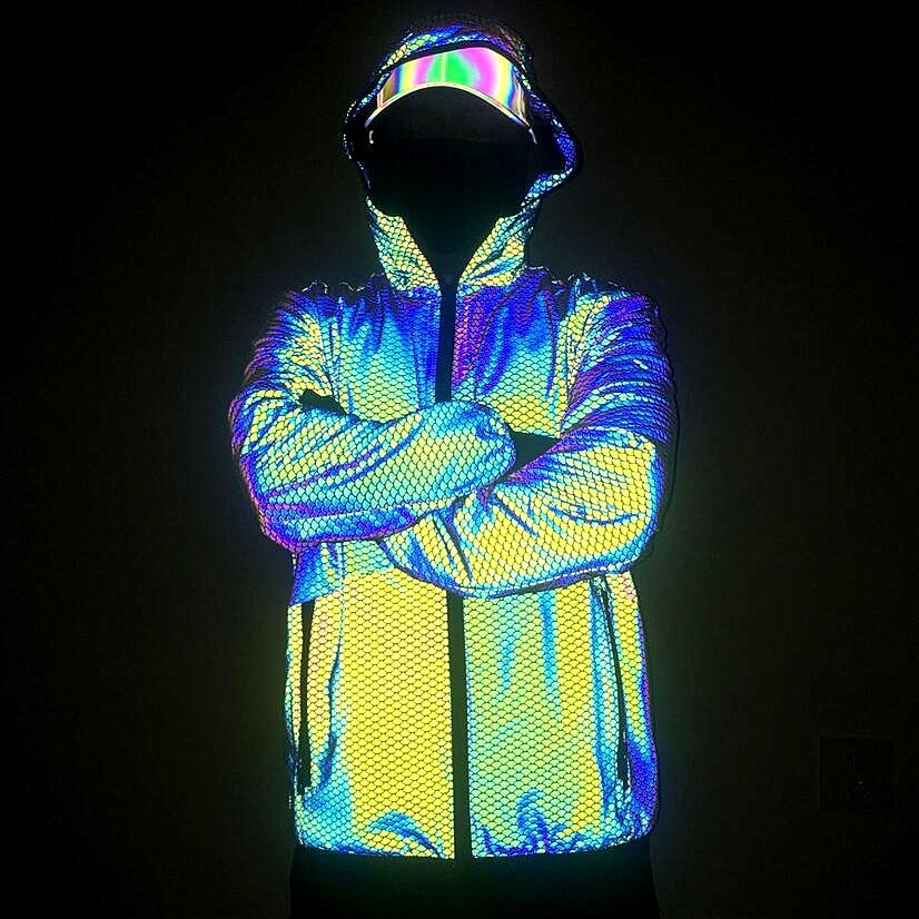 Front view of a hooded reflective jacket glowing in rainbow colors on a model