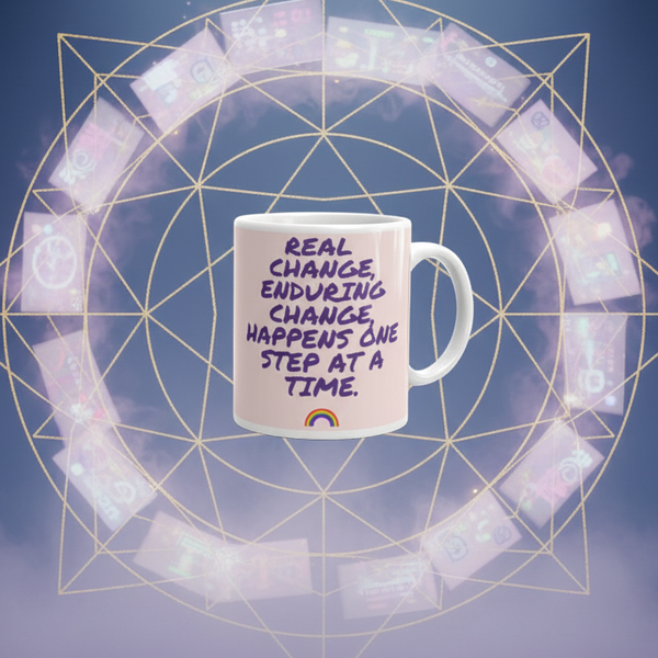 Pink mug with purple text, “Real change, enduring change happens one step at a time,” and a rainbow