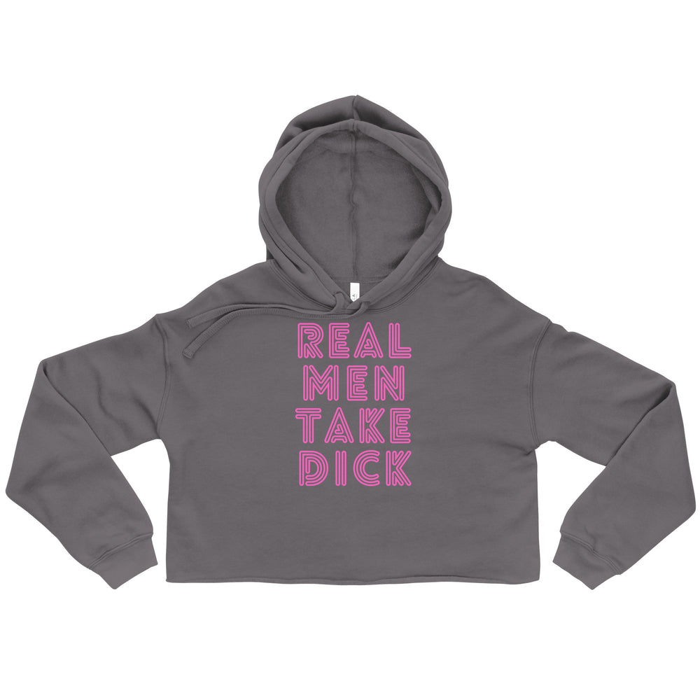 Gray crop hoodie with drawstring hood, front reads “REAL MEN TAKE DICK” in bold pink retro-outlined text; queer pride staple.