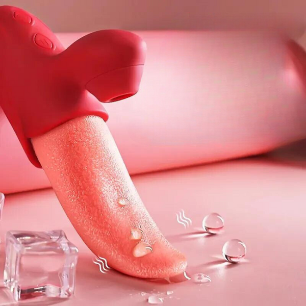 Close-up of a pink realistic tongue-shaped pleasure toy beside an ice cube and water droplets