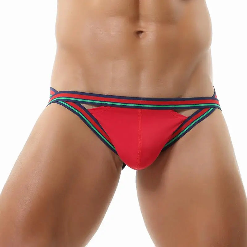Red jockstrap with green and navy striped waistband and leg straps, front view on a model