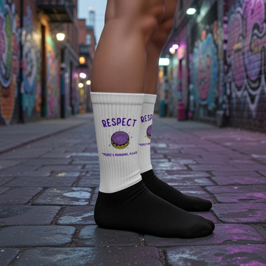 Crew socks with “RESPECT” and “People’s pronouns, please”, purple planet detail, cushioned sole; worn with black shoes.