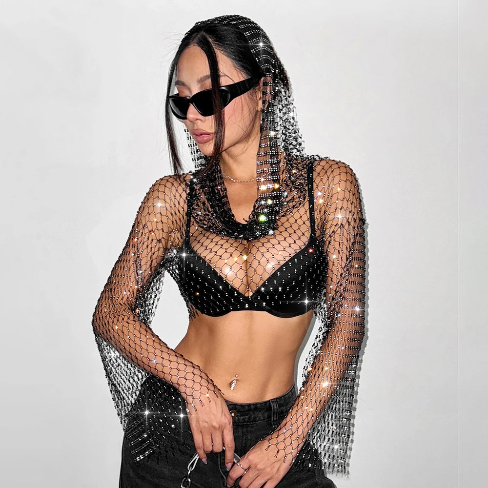 Model wearing a black rhinestone fishnet hooded top over a black bra
