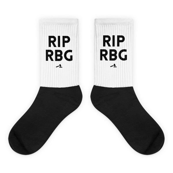 Pair of black-and-white crew socks reading “RIP RBG” with small gavel graphics