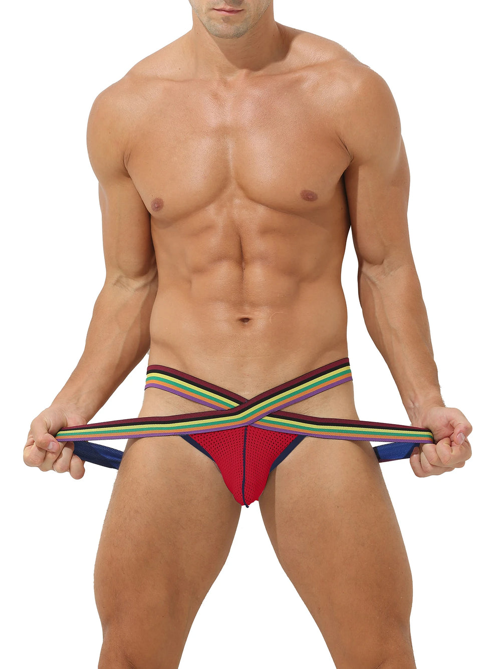 Front view of a model in a red mesh thong with rainbow double-string sides, pulling the straps outward