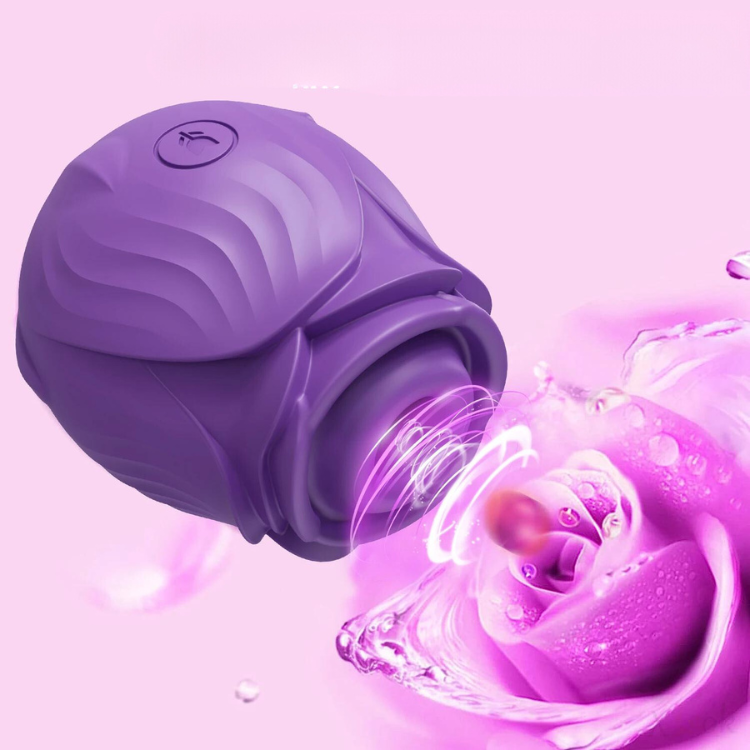 Purple rose-shaped clitoral vibrator shown close up beside a water-splashed flower