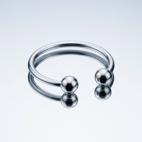 Polished silver open cock ring with two rounded end balls, shown at an angle on white