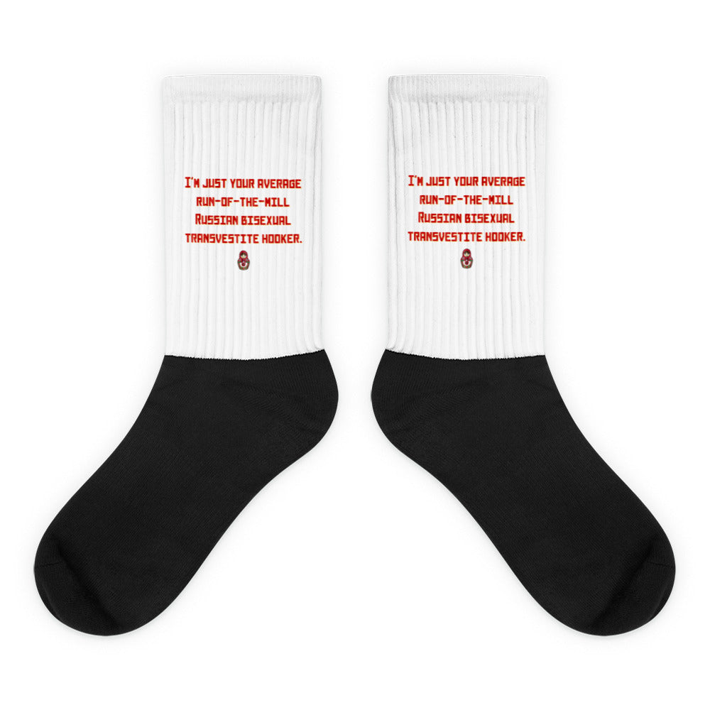 Pair of black-and-white crew socks with red text and a small matryoshka graphic