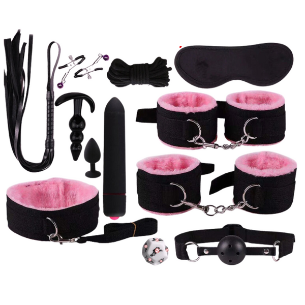 Flat lay of a black S&M beginner kit with cuffs, blindfold, flogger, gag, and accessories