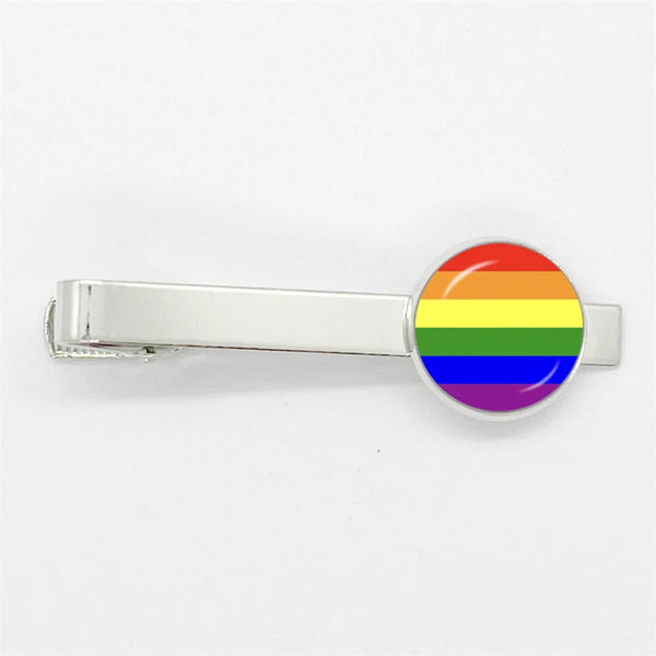 Silver tie clip with a round rainbow Pride flag emblem on a white background