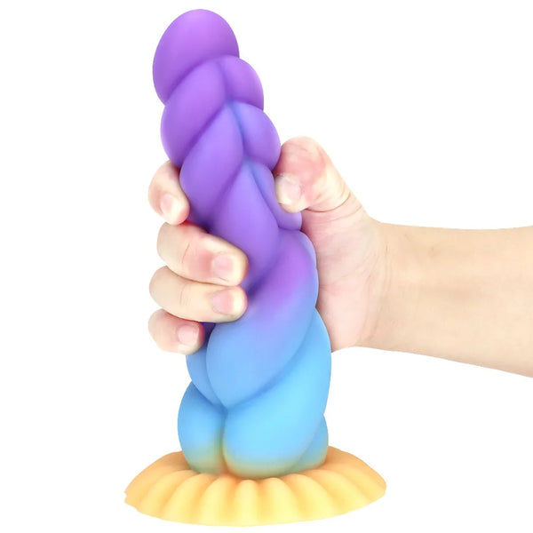 Purple and blue alien dildo with textured ridges and a yellow suction-cup base, held upright