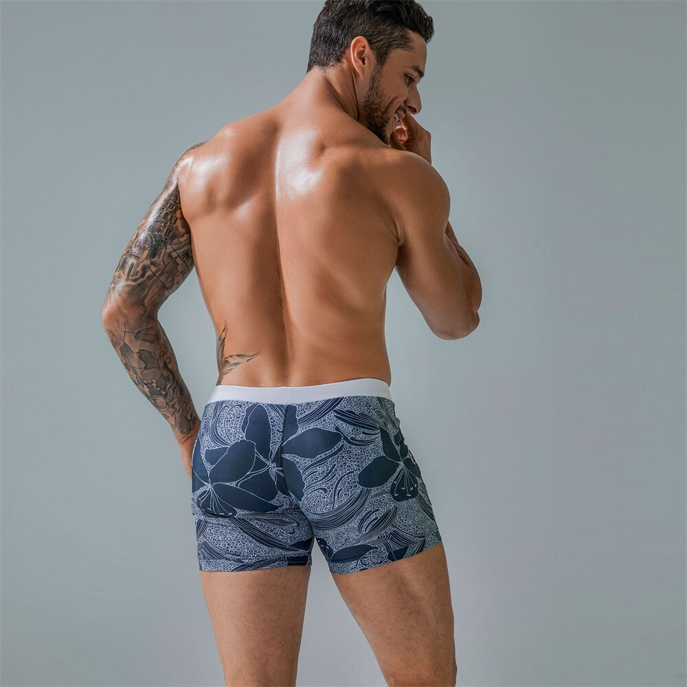 Rear view of a person wearing navy patterned board shorts with a white waistband