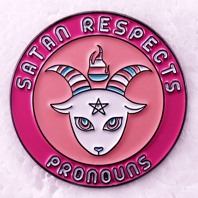 “Satan Respects Pronouns” enamel pin with a striped-horned goat design