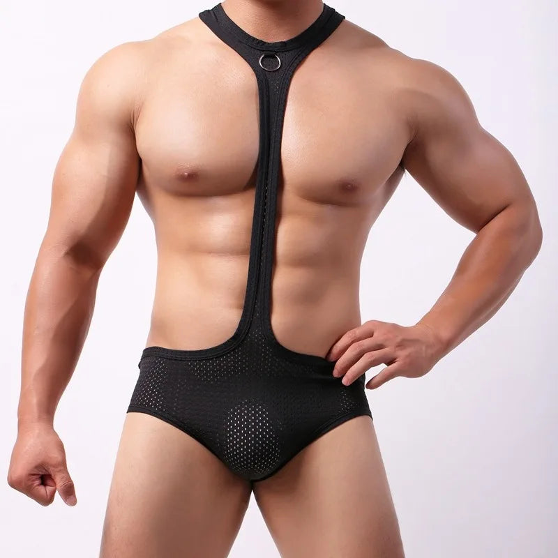 Front-view muscular model wearing a black sheer mesh bodysuit with a ringed chest strap