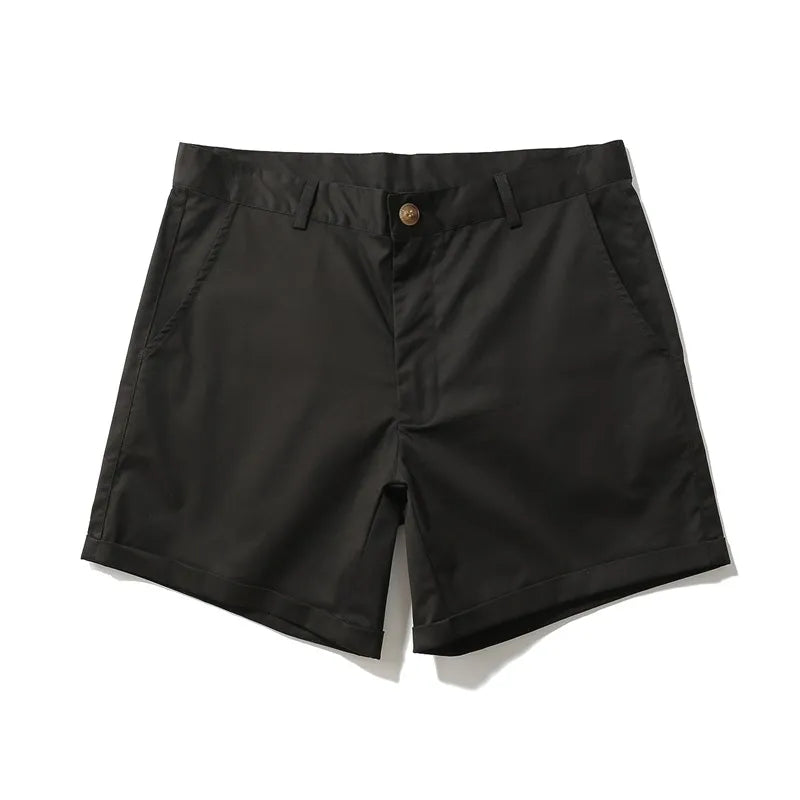 Front view of black slim-fit shorts with slanted pockets, belt loops, button closure, and cuffed hems