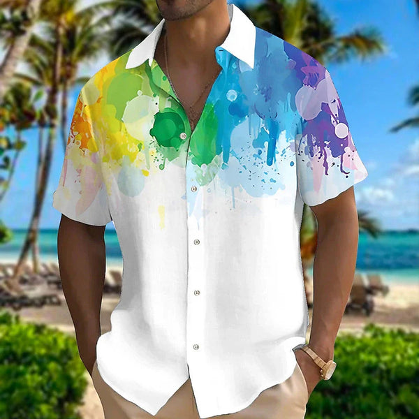 Model wearing a white short-sleeve button-up shirt with colorful rainbow paint splashes