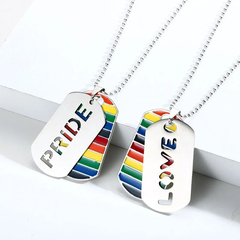 Two silver-tone rainbow dog tag necklaces, one reading PRIDE and the other LOVE