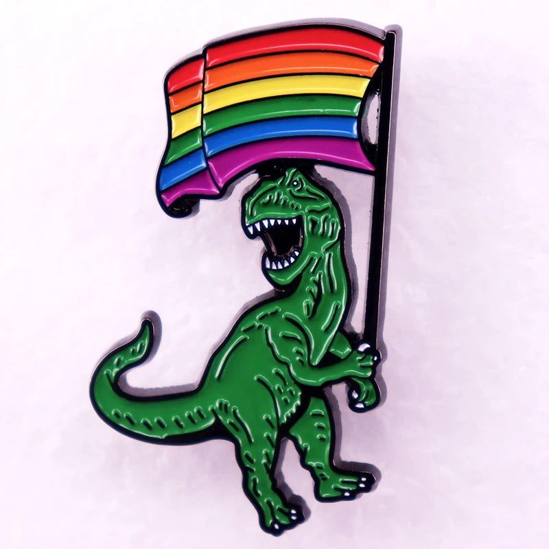 Tyrannosaurus rex enamel pin holding a rainbow Pride flag