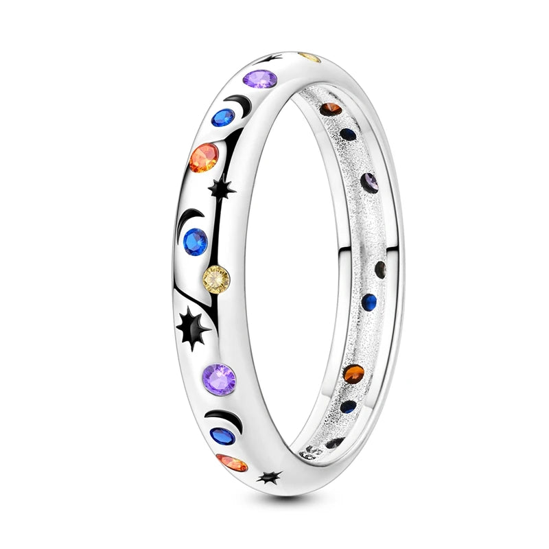 Silver ring with multicolored rhinestones and black celestial symbols
