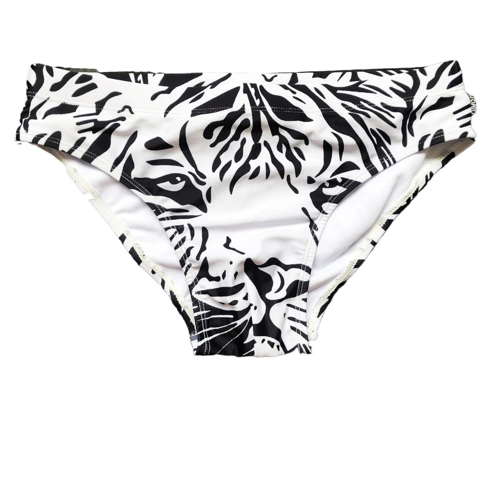 Front view of a white swim brief with bold black zebra-stripe animal print