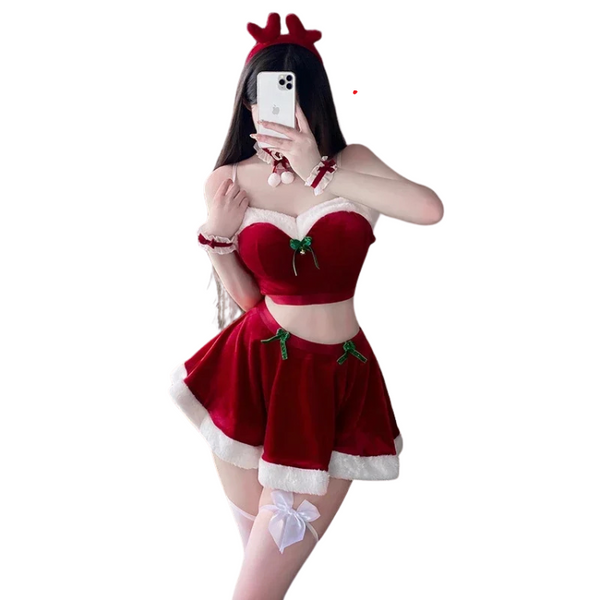 Front-facing model taking a mirror selfie in a red Santa crop-top costume and skirt