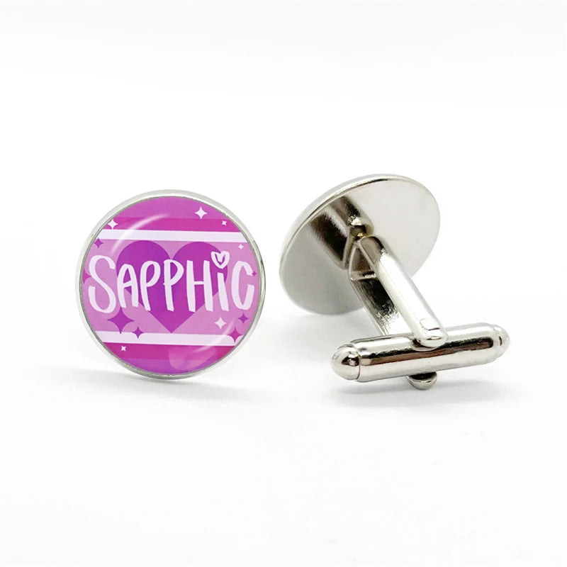 Sapphic cufflinks, one showing pink-purple heart artwork and the other its silver T-bar fastening