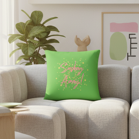 Bright green Sashay Away Pillow with bold pink and yellow "Shiny Always!" text on light gray couch in cozy queer-inspired