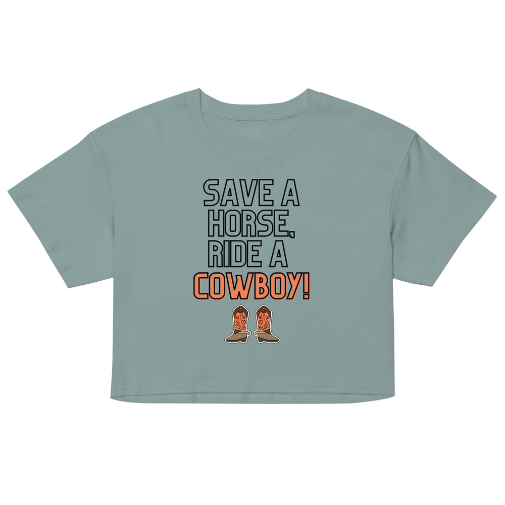 Front view of a sage green cropped T-shirt reading “SAVE A HORSE, RIDE A COWBOY!” with cowboy boots