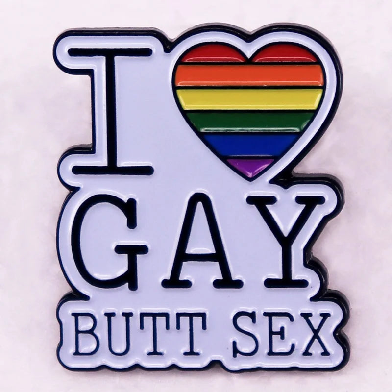 Enamel pin reading “I LOVE GAY BUTT SEX” with a rainbow-striped heart