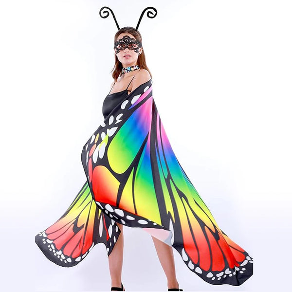 Model wearing rainbow butterfly wings with black edging and a matching masquerade eye mask